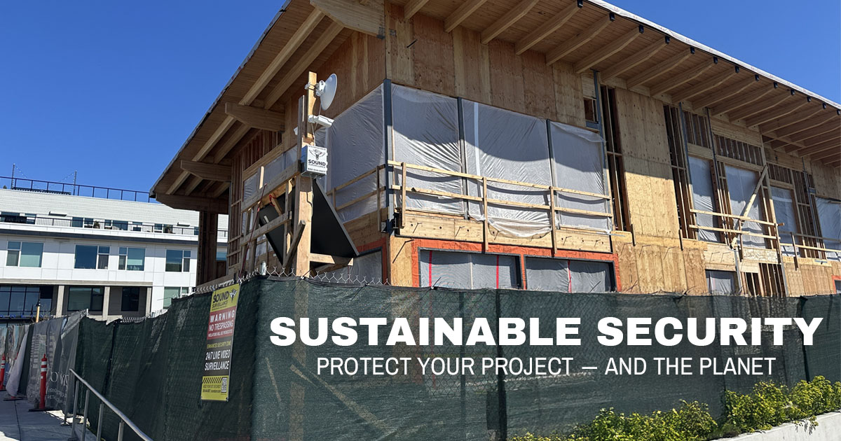 Sound Surveillance security system protecting a sustainable construction site with wood framing and green fencing under a clear blue sky.